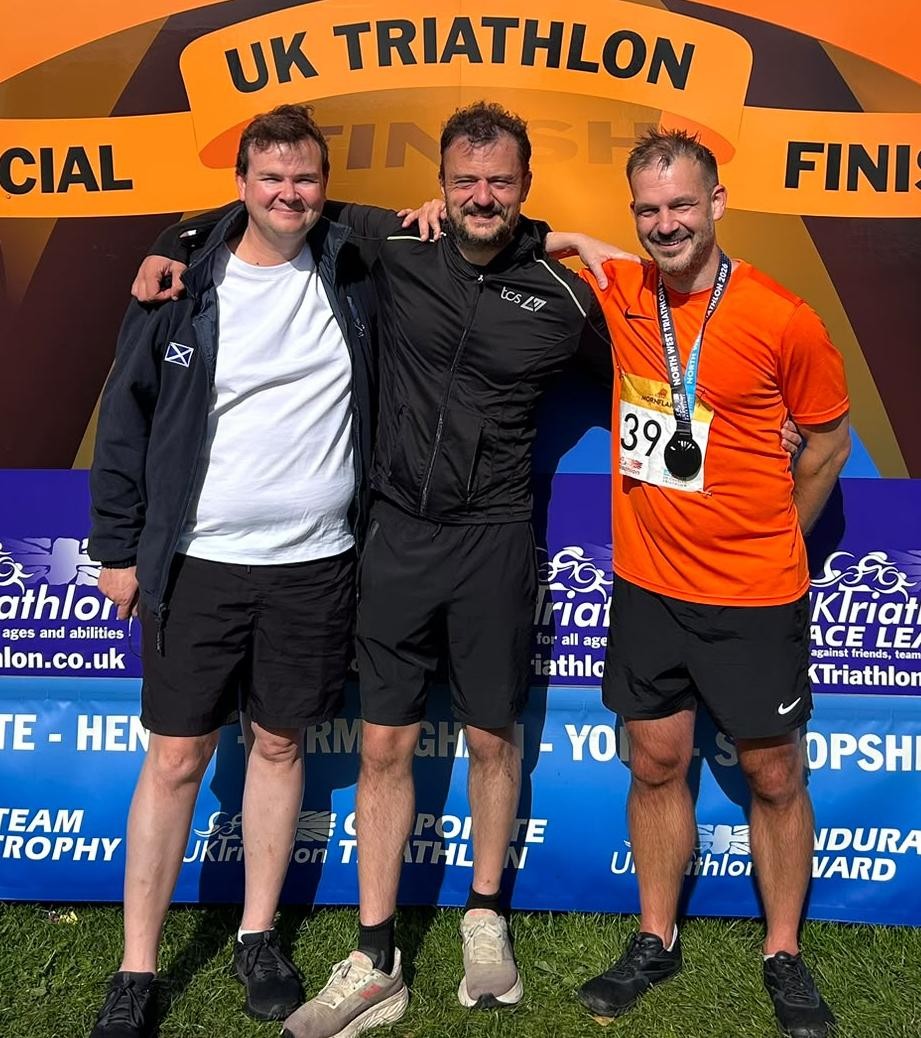Dave, Gilbo and Alistdair together at the finish arch, eighteen years after their first triathlon together